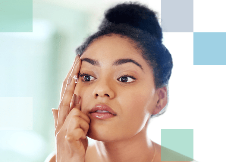 Woman inserting a contact lens into her right eye