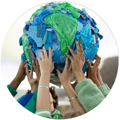 Hands of multiple ethnicities working together to hold up an Earth structure made of plastics